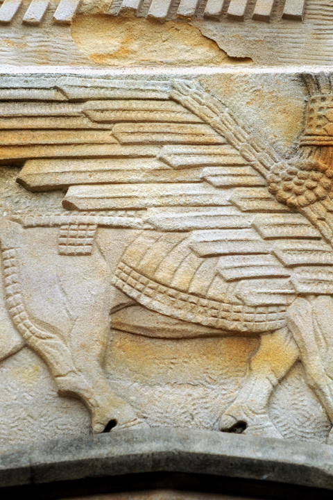 Stone carving of a mythical man-bull with wings