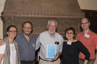 Stephen Anderson poses holding a copy of his festschrift. Also in the picture are Claire Bowern, Larry Horn, Raffaella Zanuttini, and Bob Frank.