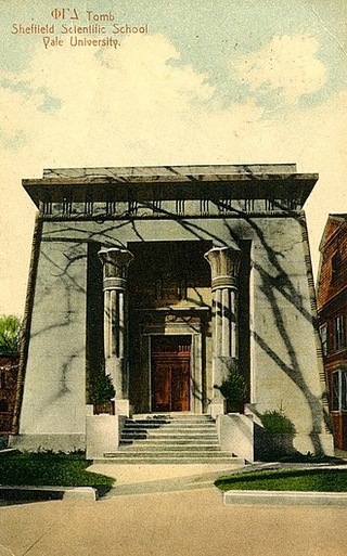 A stone facade with Egyptian columns on both sides of the door.